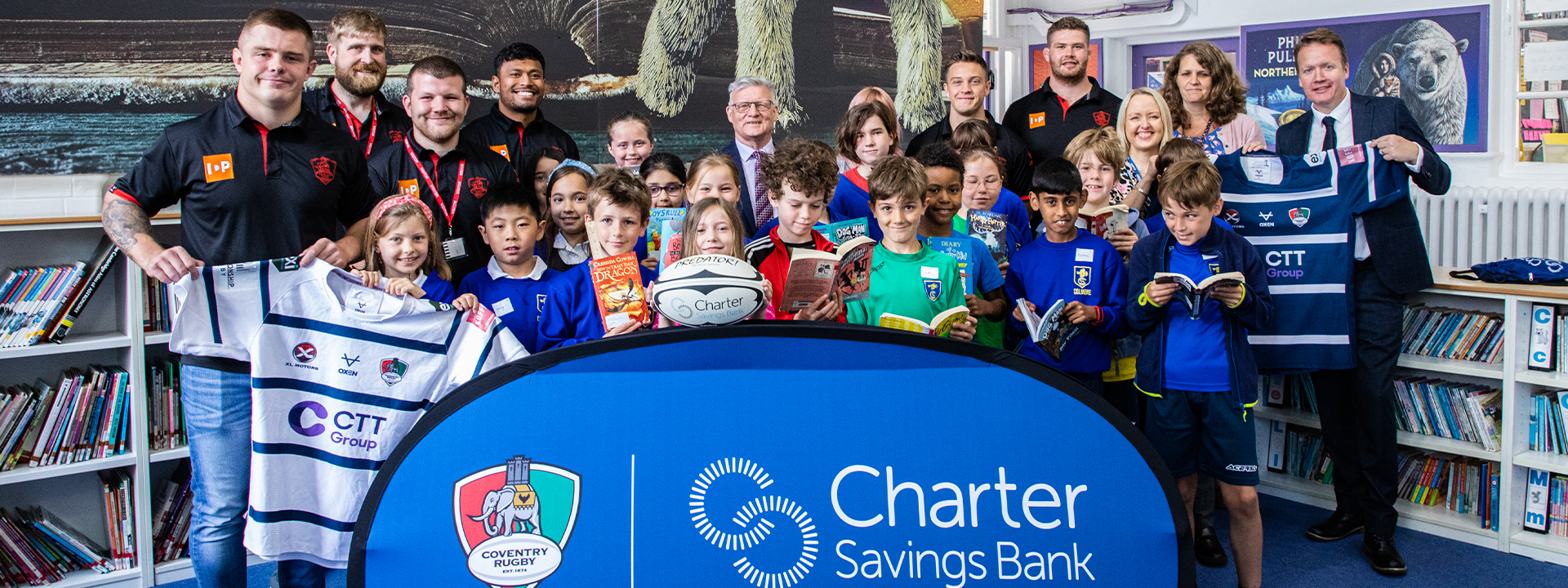 charter savings bank rugby players and colmore school children with banners and t shirts
